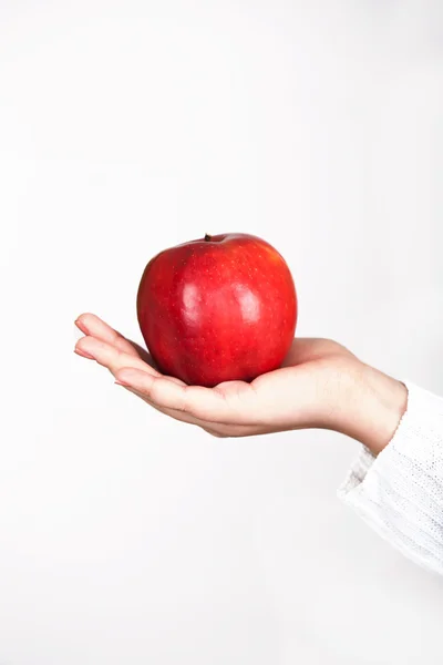 stock image Red apple in female hand