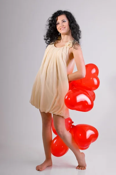 Beyaz zemin üzerine kırmızı kalp balon kadınla — Stok fotoğraf