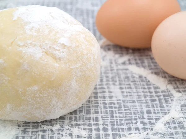 Piece of the test near eggs — Stock Photo, Image