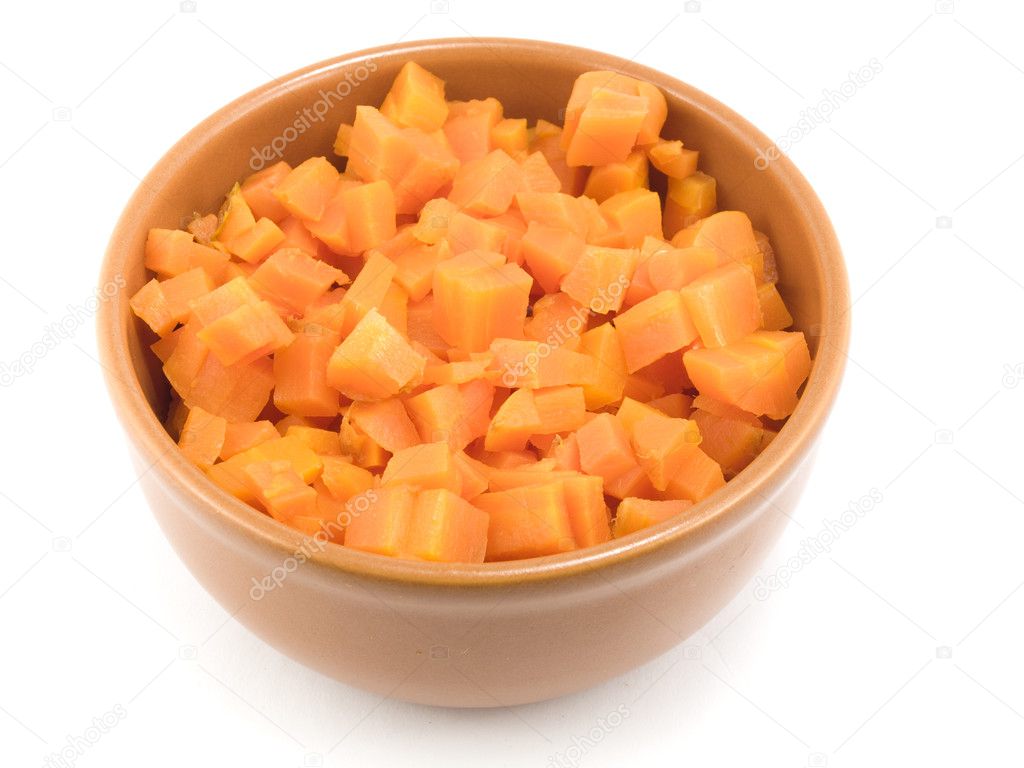 The plate with boiled carrots which is already cut by cubes for salad