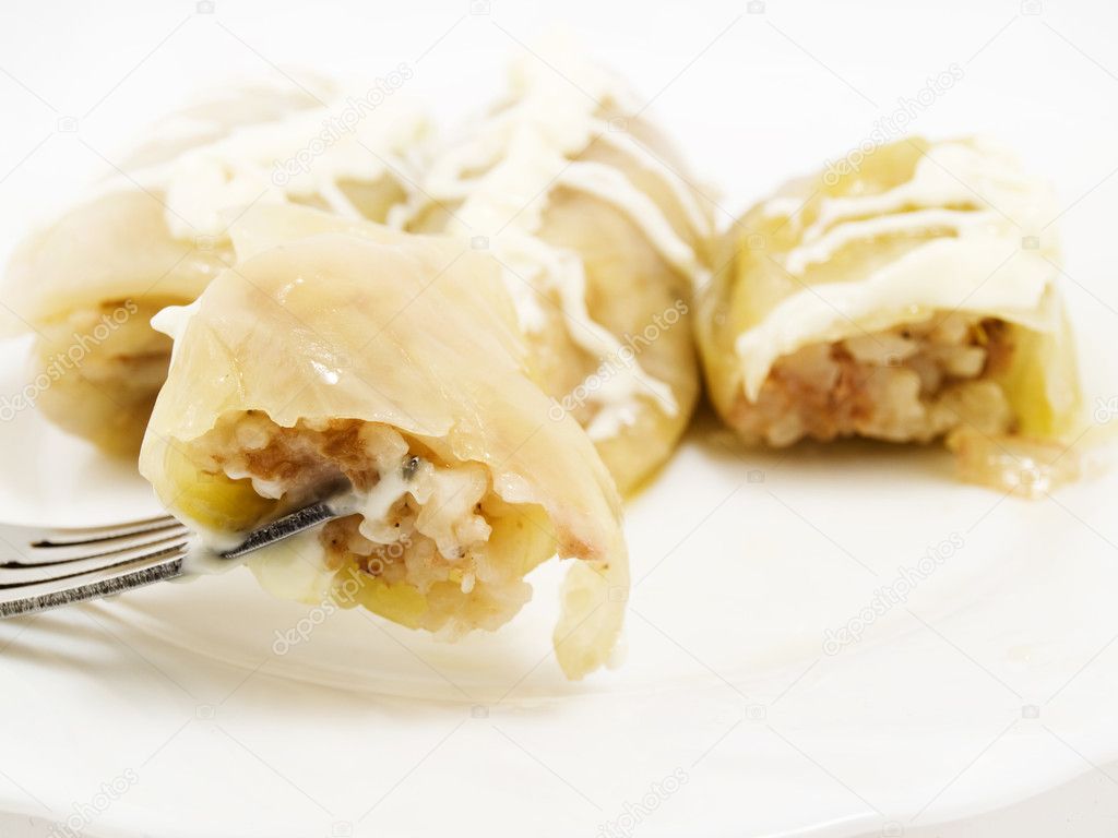 On a plug the piece of a stuffed cabbage with rice is strung