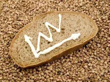 The bread slice lies on buckwheat grains And on bread the schedule with an obvious tendency of growth of the price is drawn clipart