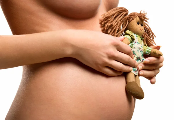 Pregnant woman holding a doll — Stock Photo, Image