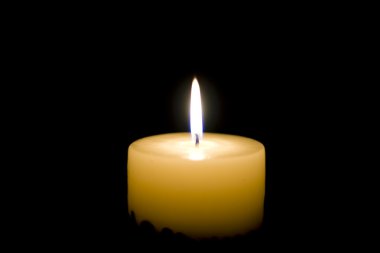 Close-up view of the candle in the night clipart