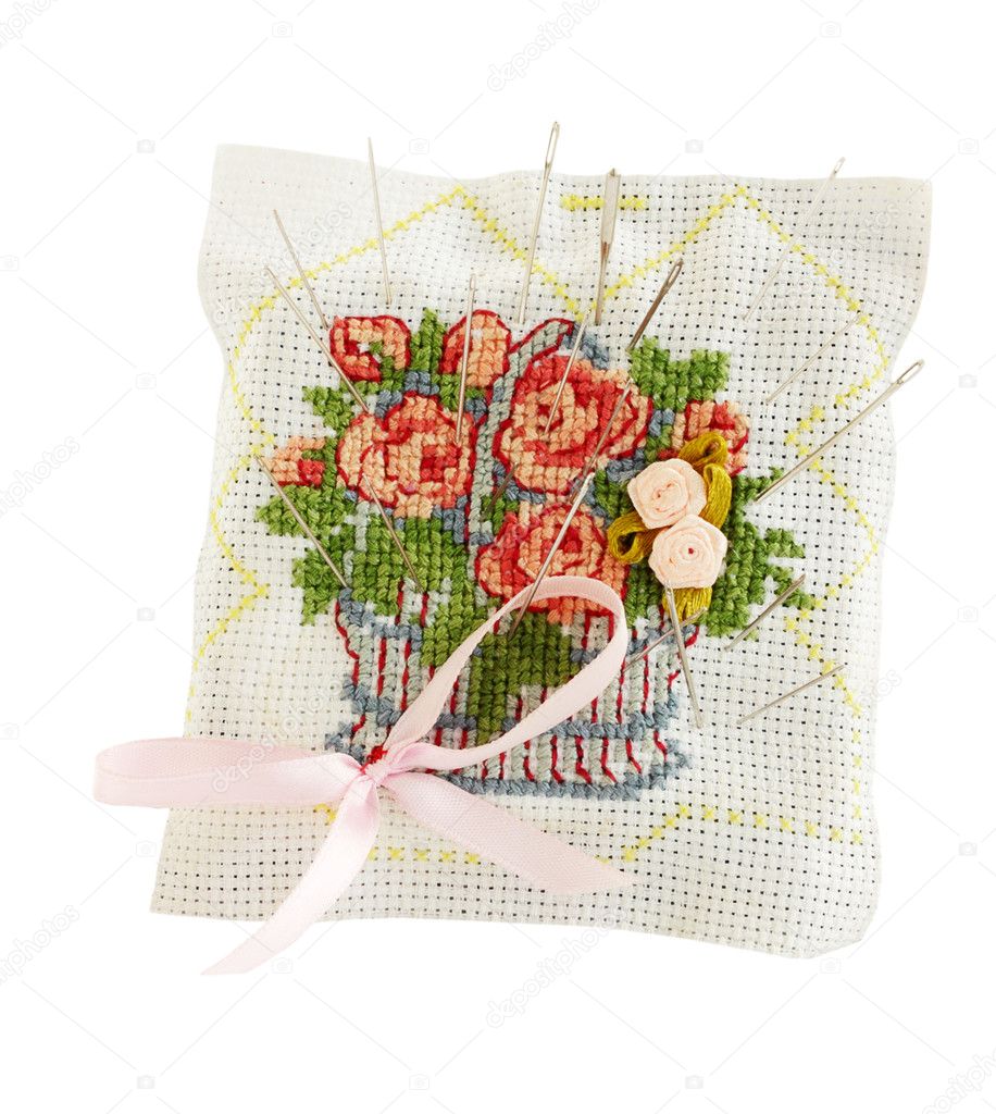 Embroidered pillow with the needles on the white