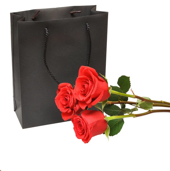 Black gift bag with red rose — Stock Photo, Image