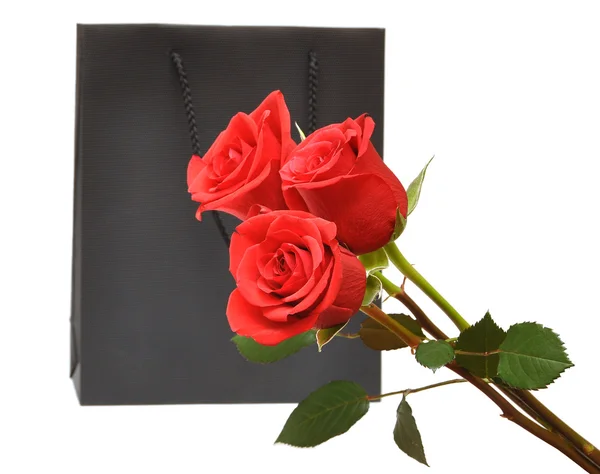 Black gift bag with red roses — Stock Photo, Image