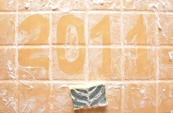 Word "2011" made of foam on wall — Stock Photo, Image