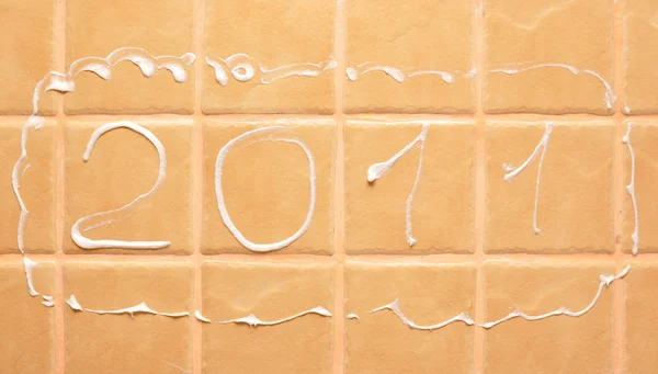 Palavra "2011" feito de espuma na parede — Fotografia de Stock