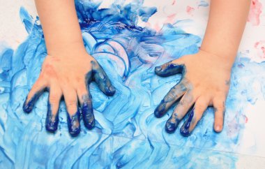 Child hands painted in blue paint clipart