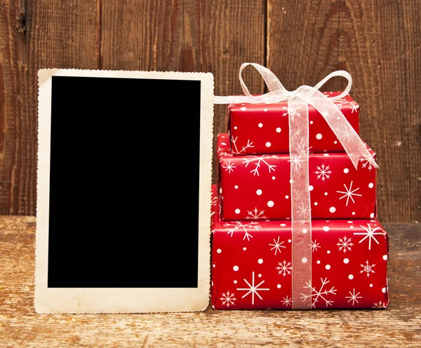 Christmas gift boxes and old empty photo — Stock Photo, Image