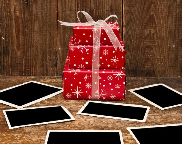 Christmas gift boxes and old empty photos — Stock Photo, Image