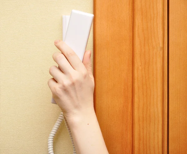 stock image Female hand holding intercom phone