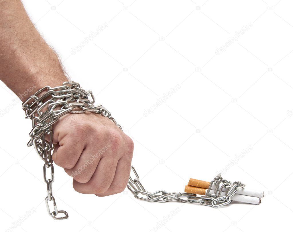 Hand chained to cigarettes on white
