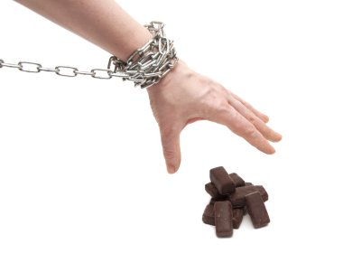 Woman's hand in chains reaching for candy clipart