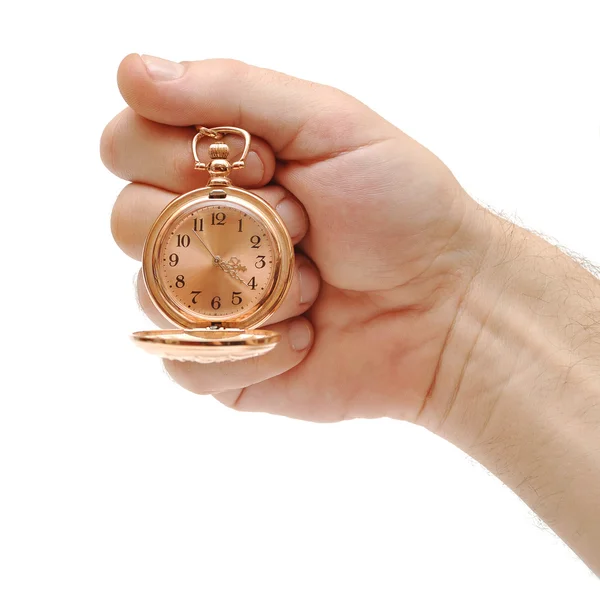 Goldene Taschenuhr in der Hand auf weiß — Stockfoto