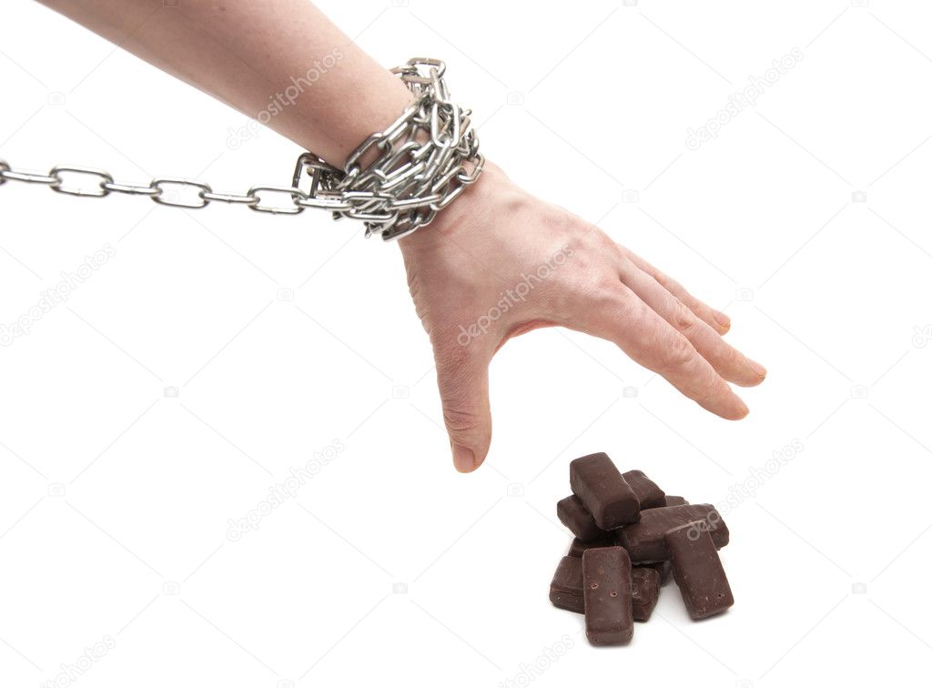 Woman's hand in chains reaching for candy