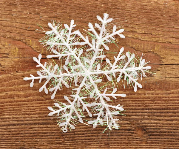 Snowflake on wooden background — Stock Photo, Image