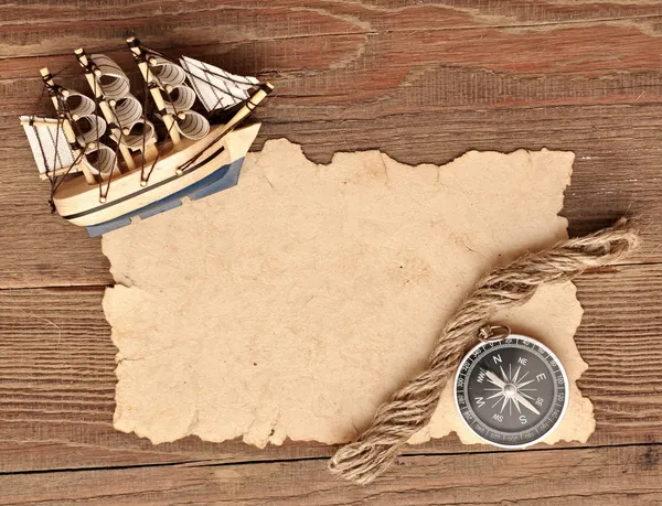 Old paper, compass, rope and model classic boat on wood backgrou — Stock Photo, Image
