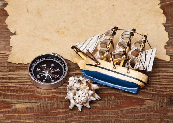 Old paper and model classic boat on wood background — Stock Photo, Image