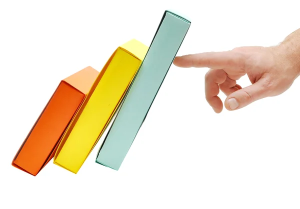 Mão segura as caixas coloridas caindo — Fotografia de Stock