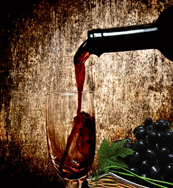 Rotwein und schwarze Trauben — Stockfoto