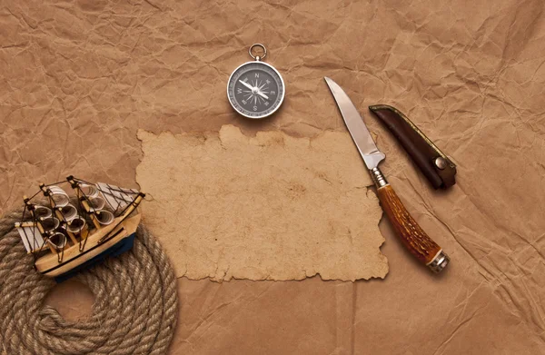 Adventure decoration with compass on old paper — Stock Photo, Image