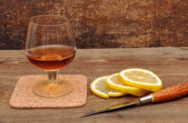 Classic cognac with lemon and knife clipart