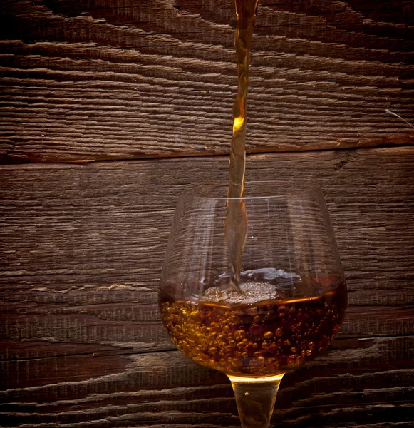 The glass with splashes brandy — Stock Photo, Image