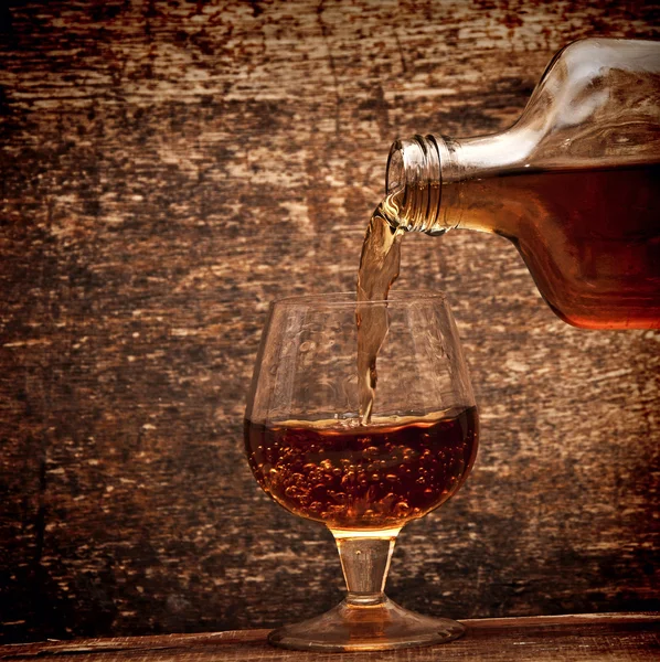 Cognac Pour Bottle Glass Wood Background — Stock Photo, Image