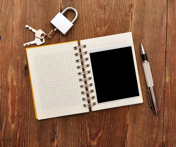 Notebook with old photo and lock and key Royalty Free Stock Images