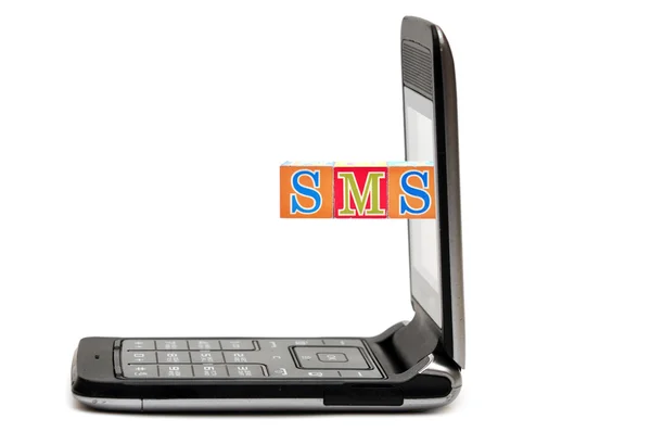 Mobile phone with abbreviations SMS, from color blocks — Stock Photo, Image