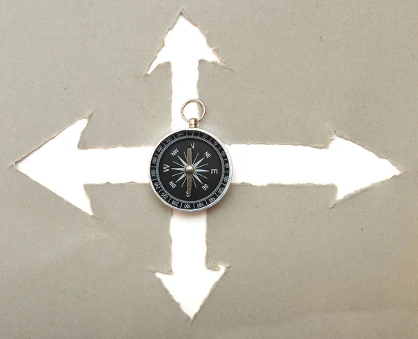 Compass and cardboard navigation arrows — Stock Photo, Image