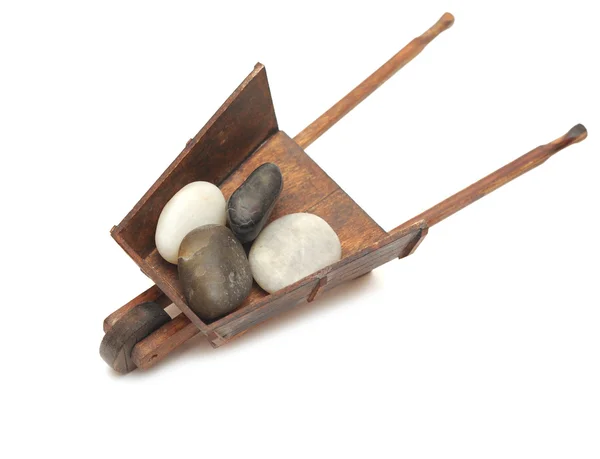 Miniature model of the wheelbarrow with stones — Stockfoto