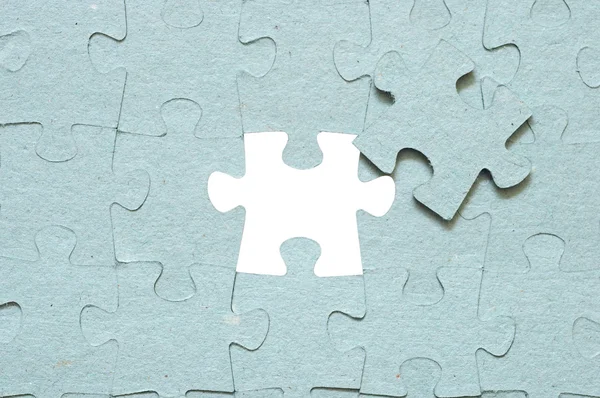 Grey puzzle with missing piece — Stock Photo, Image