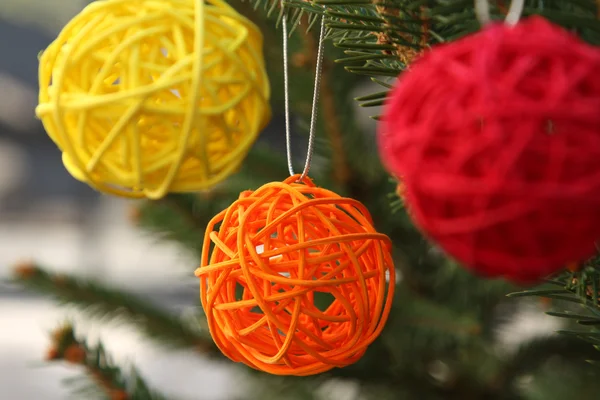 Colorful decorative wooden balls on Christmas tree — Stock Photo, Image