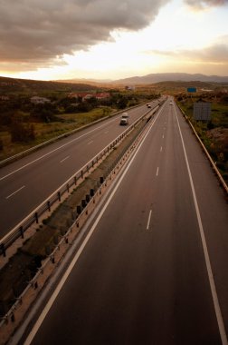 Road and the cloudy sunset sky clipart