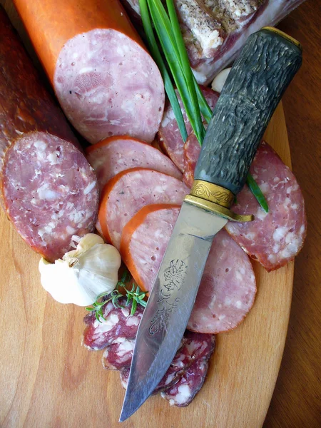 Sausages on a wooden cutting board — Stock Photo, Image