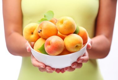 Crockery with mellow apricots. clipart