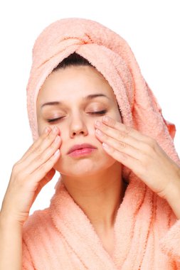 Young woman is doing massage of face skin. clipart