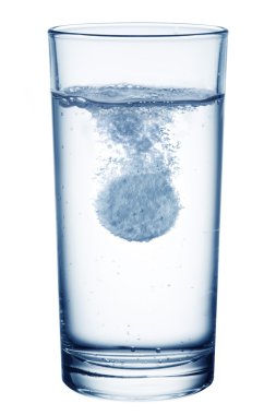 Fizzy pill in the glass of water. clipart