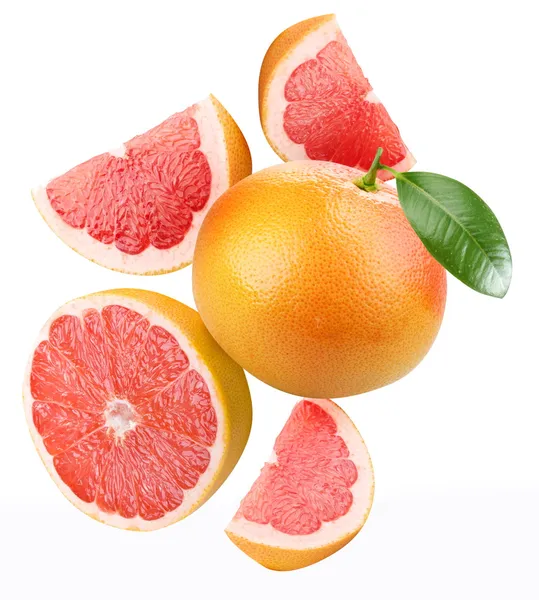 Klesající grapefruity a grapefruity plátky. — Stock fotografie