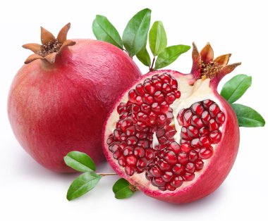 Juicy pomegranate and its half with leaves.
