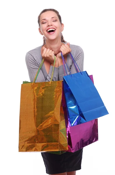 Glückliche junge Frau mit Einkaufstaschen an den Händen. — Stockfoto
