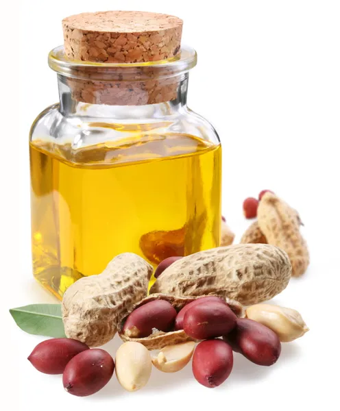 Botella de aceite de cacahuete con nueces — Foto de Stock