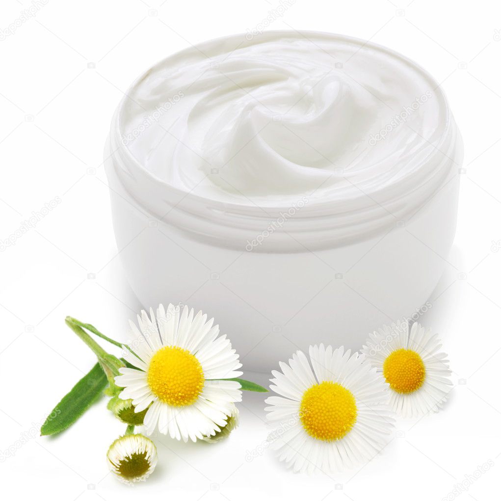 Opened plastic container with cream and camomile.