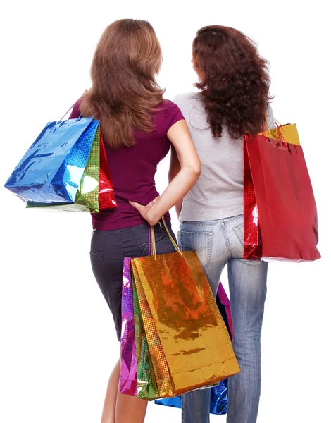 Två vänner från baksidan med shopping på en vit bakgrund — Stockfoto