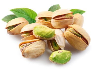 Pistachios with leaves on white background clipart