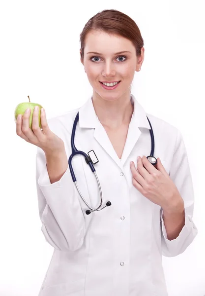 Doktor drží v ruce jablko. — Stock fotografie