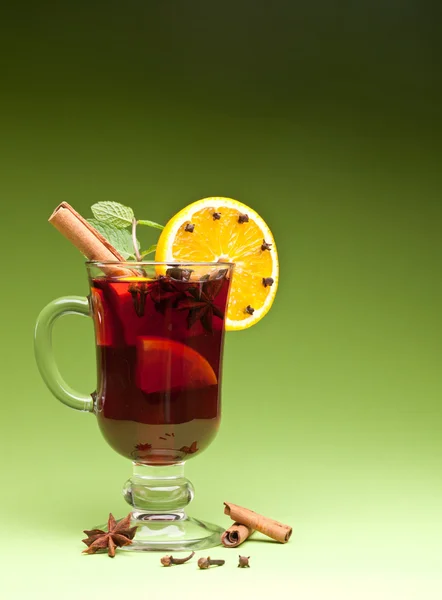 Glass of mulled green on a green background — Stock Photo, Image
